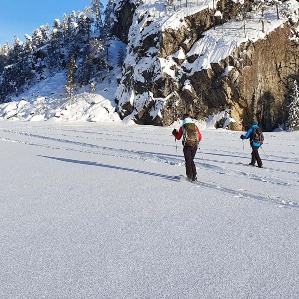 Two skiers on snowy lake.