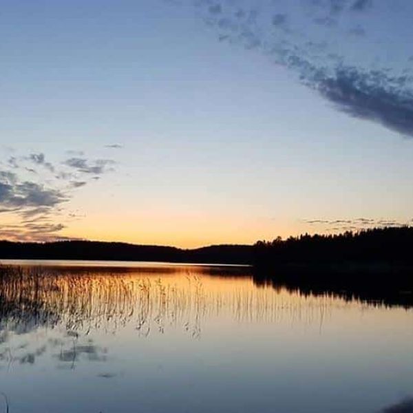 A calm lake in the evening twilight.